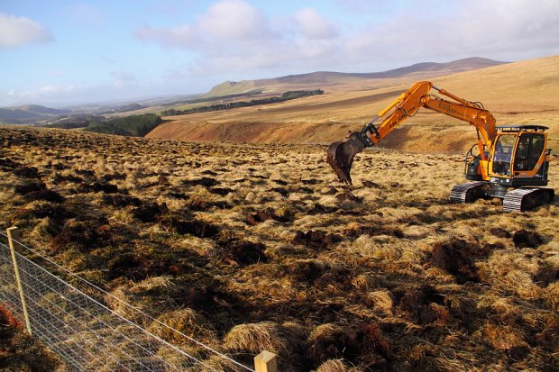 Andrew mounding in the sunshine, we prefer to flip the mounds back into the hole to leave a flatter site
