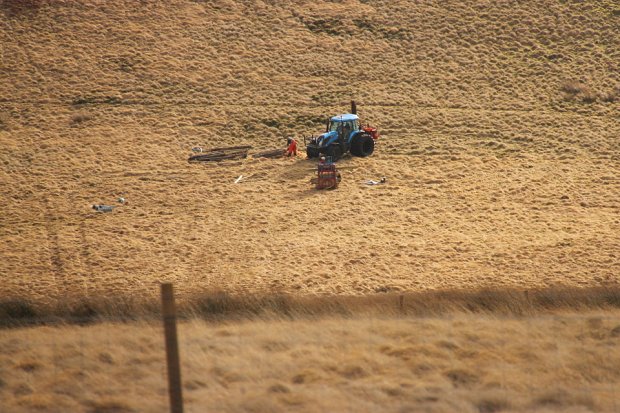 Sorting through fencing materials before laying them out