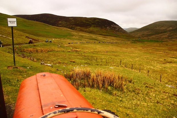 Watching a stream of tractors winding through the hills